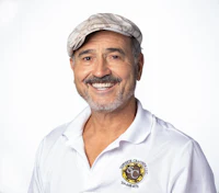 a smiling man in a white polo shirt