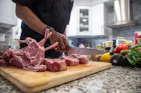 a man is slicing meat on a cutting board