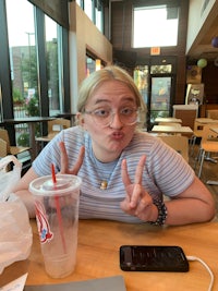 a woman making a peace sign