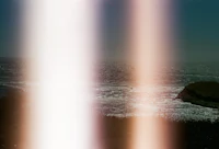 a person is riding a surfboard near the ocean