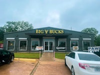 a big bucks store with cars parked in front of it