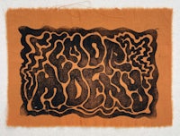 a piece of cloth with a black and orange design on it