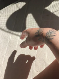 a person's hand with a tattoo on it