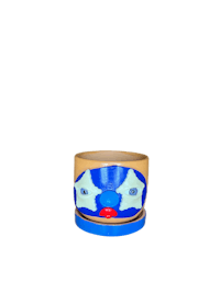 a blue and white ceramic pot with a face on it