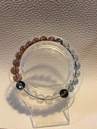 a bracelet with blue, brown, and black beads