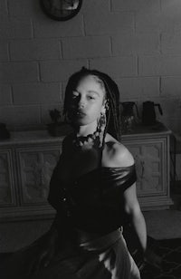 a black and white photo of a woman sitting in a room