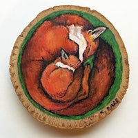 a piece of wood with a painting of a fox and a fox cub