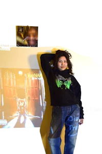 a girl posing in front of a projection screen
