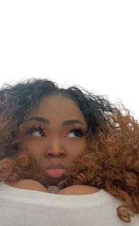 a woman with curly hair looking up at the camera