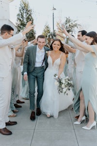 a group of bridesmaids and groomsmen are waving to the camera