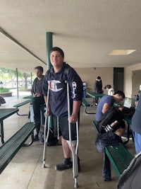 a group of people standing in a hallway with crutches