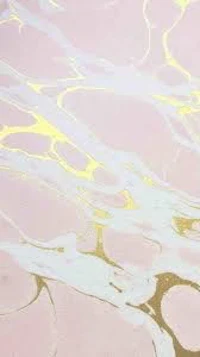 a marble floor with gold and pink paint on it