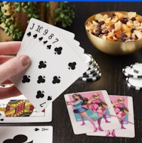 a person is holding a deck of playing cards