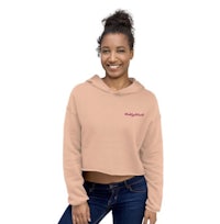 a woman wearing a beige cropped hoodie