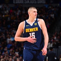 denver nuggets player standing on the court