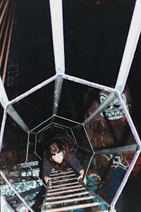 a person climbing a ladder in a dark room