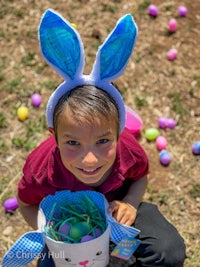 a young boy wearing an easter hat and bunny ears