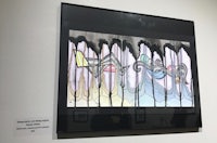 a piece of art hanging on a wall