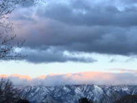 a view of the mountains with clouds in the sky