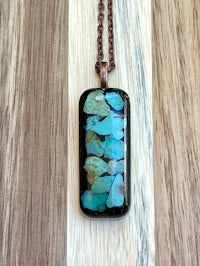 a necklace with a turquoise stone on it
