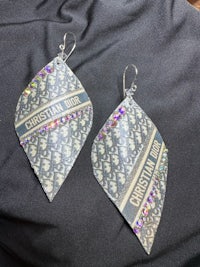 a pair of earrings with rhinestones on them