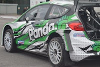 a green and white car with a panda logo on it
