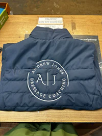 a jacket with a logo on it sitting on a table