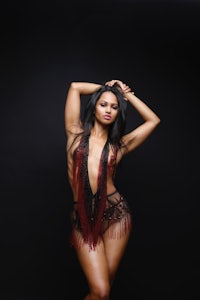 a woman in lingerie posing on a black background