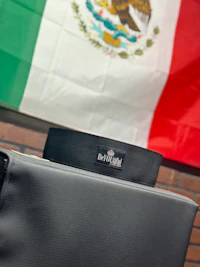 mexican flag in front of a black bag