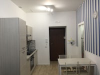 a small kitchen with a blue and white striped wall