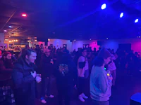 a crowd of people standing in a dark room