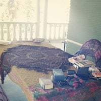 a table on a porch with books on it