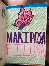 a notebook with a drawing of a butterfly on it