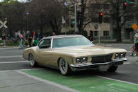 a tan car parked on a street
