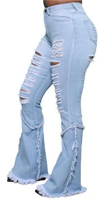 a woman wearing flared jeans with ripped hems