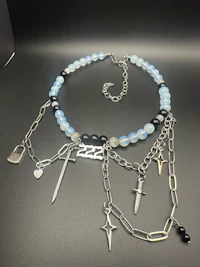 a bracelet with silver and blue beads and a sword