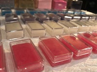 a variety of different colored lip balms on a table