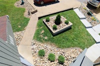 an aerial view of a yard with a car parked in it