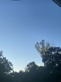 a blue sky seen from a car window
