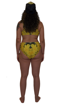 the back view of a woman in a yellow bikini