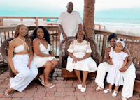 a family sits on a porch and poses for a photo