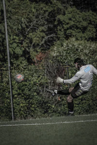 a man kicking a soccer ball