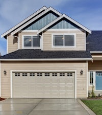 a house with a garage door in front of it