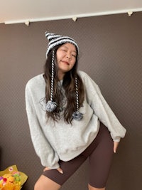 a woman wearing a striped hat and leggings