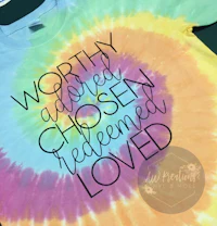 a tie dye t - shirt that says worthy, chosen, redeemed loved