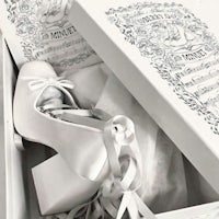 a pair of white shoes in a box