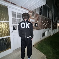 a man standing in front of a house at night