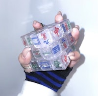 a person holding up a rubik's cube