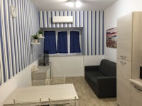 a small apartment with blue and white striped walls