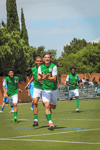 a group of men playing soccer on a field